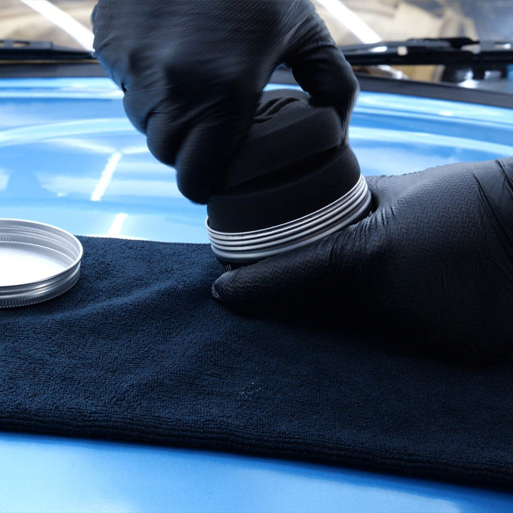 connect car wax application puck being used in tin of wax